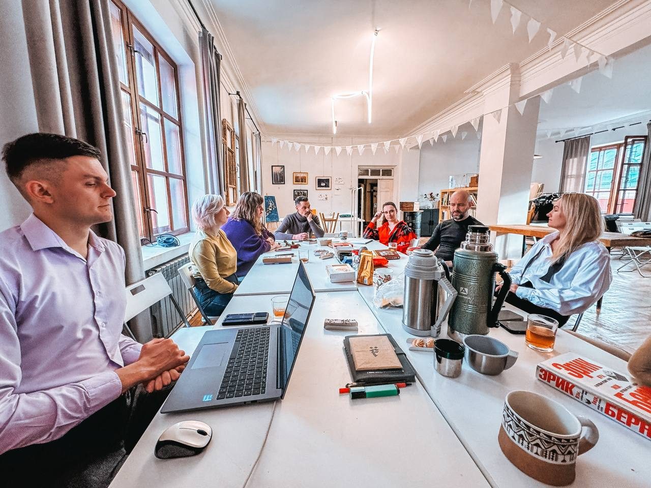 An AELITA COMMUNITY meeting — discussing the topic at the table